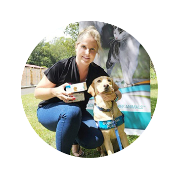 Veterinarian posing with guide dog